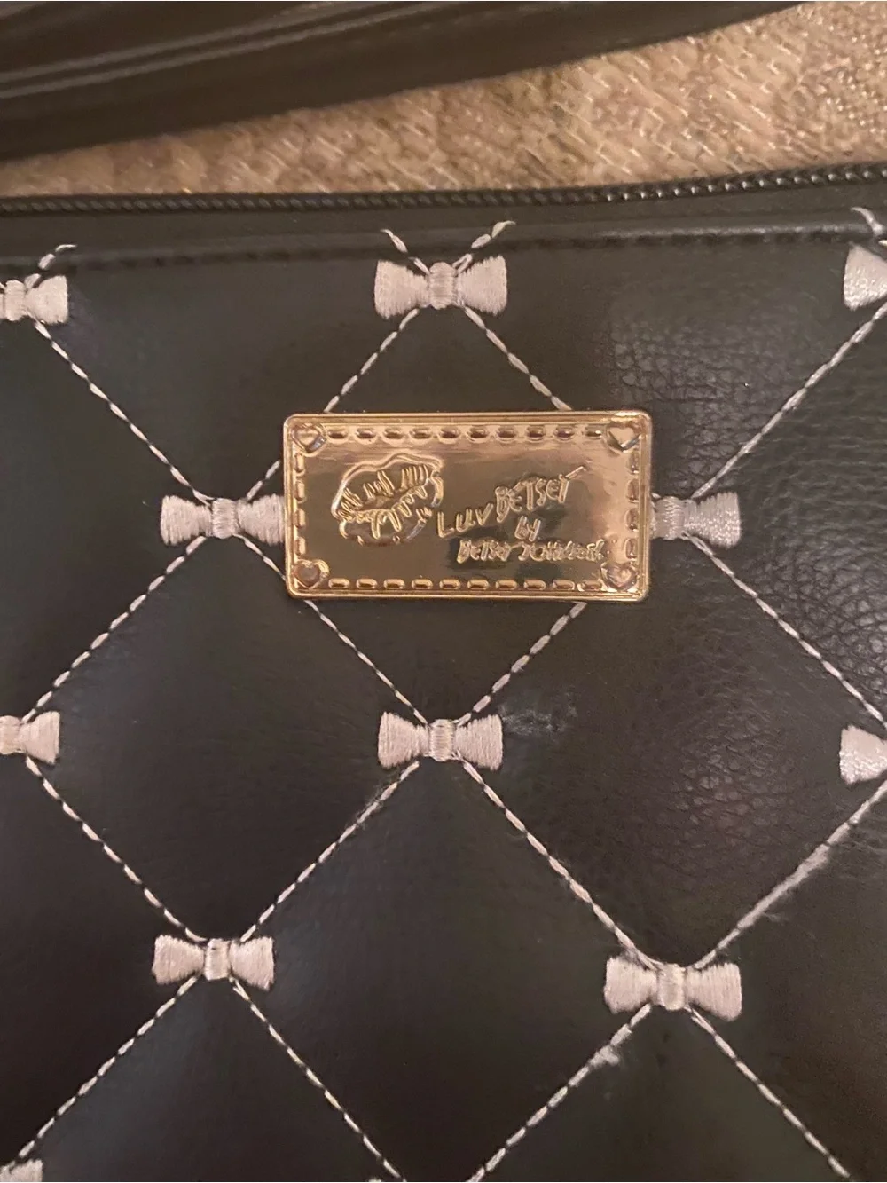 Betsey Johnson Black Quilted Bow-Print Wristlet with Gold Plaque
